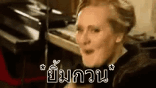 a woman is making a funny face in front of a microphone in a room .