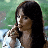 a close up of a woman smoking a cigarette