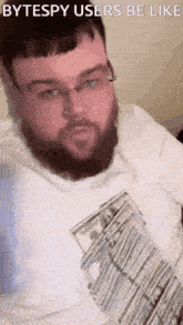 a man with a beard and glasses is holding a pile of money and says " bytespy users be like " on the bottom