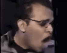 a close up of a man 's face wearing sunglasses