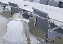 a woman in an angel costume is cleaning the floor in an office