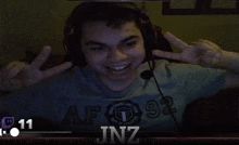a young man wearing headphones and a shirt that says af 92