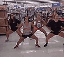 a group of women are standing in a circle in a store .
