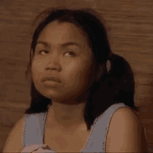 a woman with pigtails is making a funny face while looking up .