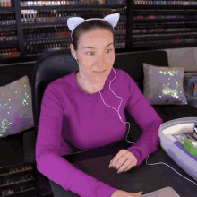 a woman wearing headphones and a cat ear headband