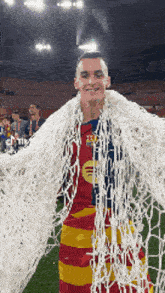 a soccer player is wrapped in a soccer net
