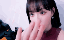a close up of a woman covering her face with her hands