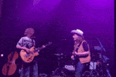 a cosmic country band on stage with purple lights