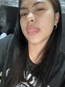 a girl wearing a black shirt that says ' nirvana ' on it