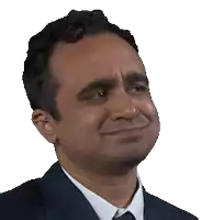 a man in a suit and tie is making a funny face .