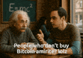 two men sitting at a table with e = mc2 written on the blackboard behind them