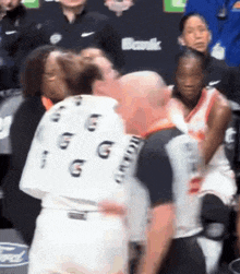 a man in a gatorade shirt kisses a woman