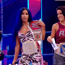a woman in a wrestling ring holding a belt that says ' boss ' on it
