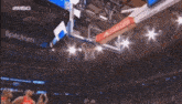 a basketball game is being played on a court with spectrum advertisements on the sidelines