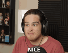 a man wearing headphones and a red shirt says " nice "
