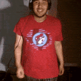 a man wearing headphones and a red shirt with a squirrel in a circle