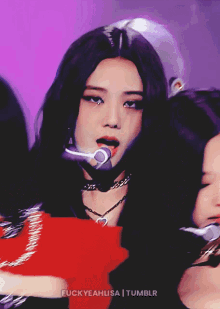 a close up of a woman singing into a microphone with the words fuckyeahlisa tumblr on the bottom