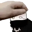 a hand is holding a card over a person 's head .