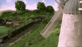 a train is going by a windmill in a cartoon scene