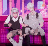 a couple of anime characters sitting on a couch