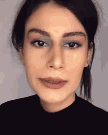 a close up of a woman 's face with makeup on her face