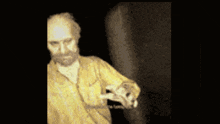 a blurry picture of a man with a beard holding something in his hand