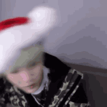 a person wearing a santa hat is sitting on a couch .