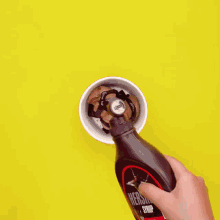 a scoop of chocolate ice cream is being poured into a cup that says oppo