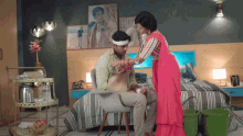 a man with a bandage on his head is being helped by a woman