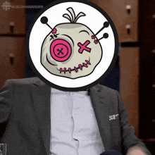 a man in a suit has a picture of a voodoo doll in front of his face