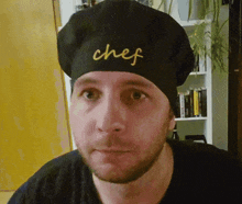 a man wearing a chef hat with the word chef on it