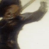 a blurry picture of a man holding a sword in his hand