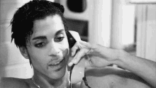 prince is talking on a cell phone in a bathtub .
