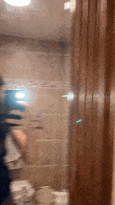a blurry picture of a person standing in front of a mirror