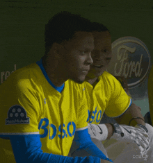 a man wearing a yellow jersey that says boston