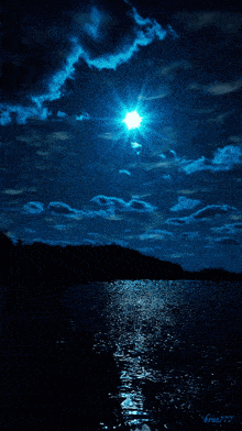 the sun shines brightly in the night sky above the water