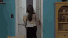 a woman with red hair is standing in a doorway with her mouth open .