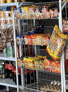 a bag of iced jam biscuits hangs from a shelf in a store