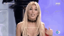 a woman wearing a choker is giving a thumbs up sign