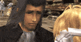 a man with a beard is standing next to a blonde woman in a video game