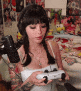 a woman is wearing headphones and holding a video game controller .