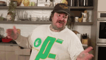 a man wearing a harley davidson hat and a green shirt with the letter e on it