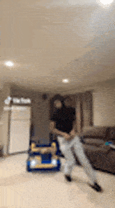 a blurry picture of a man dancing in a living room .