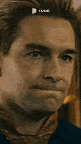 a close up of a man 's face with the word tvoe written above him