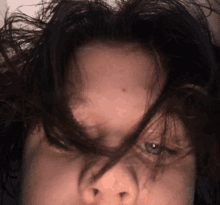 a close up of a person 's face with a few hairs visible