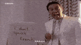 a man in a white suit stands in front of a white board that says " aaaiii "