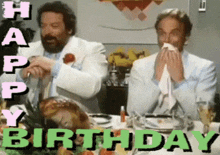 two men are sitting at a table with a turkey and the words happy birthday