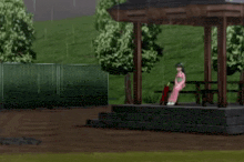 a man is holding an umbrella in front of a gazebo while a woman sits on a bench