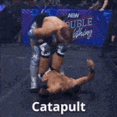 two men are wrestling in a ring with the word catapult written on the bottom