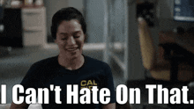a woman wearing a cal shirt is smiling and says i can 't hate on that
